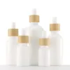 Bottiglie di olio essenziale in vetro porcellana bianca Flacone contagocce per siero per la cura della pelle con pipetta in bambù 10ml 15ml 20ml 30ml 50ml 100ml Dfplm