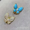 Boucles d'oreilles Van Clover Boucles d'oreilles papillon hautes en or pour femmes boucles d'oreilles asymétriques en émail bleu plein de diamants avec boucles d'oreilles en herbe à quatre feuilles