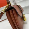 Tabou mini slät ko läder handväska tabou fyrkant liten handväska modedesigner kvinnor triumfal båglåsväska