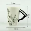 Tazze Novità 220ml Pianoforte Tazza in ceramica Nota musicale Succo di latte Tazza di limone Caffè Tazza di tè Regalo di Natale 231124