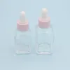 Flacon compte-gouttes carré d'huile essentielle de 20ml, flacons de sérum en verre transparent de 30ml avec bouchon rose pour cosmétique Ajkce