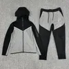 Men s Tracksuits 2023 Spring and autumn men s hooded jacket splicing suit leisure sports jogging two piece set 231127