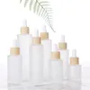 Flacone contagocce in vetro smerigliato Flacone per olio essenziale di profumo Flacone per imballaggio cosmetico Contenitore con coperchio in legno imitato 20ml 30ml 50ml 60ml 100m Ocxq