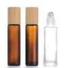 Rolo de óleo essencial de vidro em frascos com bolas de rolo de aço inoxidável e tampa de bambu 5ml 10ml 15ml Frasco de amostra de perfume recarregável Cos Jnbd