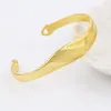 Bracciale rigido da donna a forma di onda in oro giallo pieno