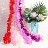 装飾的な花の壁の背景パーティー装飾シルクハイディアヘアロングラッタン人工花花園の花輪ウィステリアヴァイン