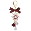 Porte-clés créatif strass perle camélia alliage porte-clés arc fleur Couple pendentif porte-clés