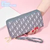 Fabriek hele dames schoudertassen 2 stijlen grote capaciteit gedrukt clutch bag dit jaar populaire dubbele rits mobiele telefoon coi249r