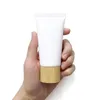 60g 80g Tubes cosmétiques en plastique bouteille tuyau de compression nettoyant pour le visage tubes d'extrusion rechargeable voyage baume à lèvres conteneur avec capuchon en bambou