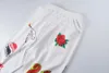 Białe spodnie dresowe spodnie doodle mężczyźni kobiety Hip Hop List wydrukowane legginsy unisex joggery sznurkowe spodnie
