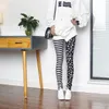 Kvinnors leggings mode svart vit tryck kvinnors sexiga rand täta elastiska tunna blyertsbyxor lolita slips trend beskuren