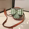 Designer Children Letter Printed Circular Handbags Kids Checkered Bow Messenger Påsar 2023 Luxury Big Girls Single Shoulder Princess Bag A9605VV