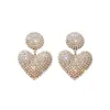 Encanto europeo y americano celebridades aretes de amor de diamantes de lujo personalidad moda OL diseño sentido aretes de corazón de melocotón aretes simples exagerados