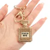 Porte-clés de bouteille de parfum en cristal pour femmes, avec nœud en diamant, en métal, pendentif de sac de voiture, petit cadeau, accessoires bijoux