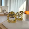 Diseñadores Pendientes de botón grandes de oro de 18 quilates Pendientes de marca de diseñador plateados Pendientes de personalidad de jaula de cristal para mujer