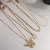 Łańcuchy modne wielowarstwowe złoto-motylowy naszyjnik łańcuchowy dla kobiet masywny wisiorek zamka imitacja perłowa biżuteria