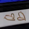 23ss pendientes de diseñador para mujer pendientes de tuerca con logo de corazón pendientes de tuerca verticales 925 pendientes de aguja de plata joyería de mujer de alta calidad a1