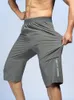 Mäns shorts sommarszipfickor män korta byxor sportkläder andas snabba torra capris byxor sträckt nylonträning gym casual 6xl