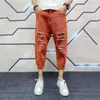 Jeans masculino Cool Men Nona calça com botão rasgado e zíper coreano Calças de cor sólida Roupas masculinas