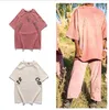ブランドTシャツデザイナーメンTシャツ夏ファッションカップルピンクのレタープリントピュアコットントップショートスリーブグラフィティハンドドドラウンドTシャツカジュアルルーズメンズティー