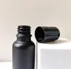 10ml 5ml 15ml 20ml 30ml 50ml 100ml Parfum Roll On Glass Bottle Black Frost avec des flacons d'huile essentielle de rouleau de boule de verre en métal JL9533