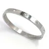 Braceuse de marque New Carter Titanium Steel Bracelet en acier inoxydable Ten Drill Buckle Bracelet à chaud