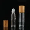 Botellas enrollables de aceite esencial de 5ml y 10ml, botella de Perfume enrollable de vidrio transparente con tapa de bambú Natural, bola de rodillo de acero inoxidable Kxdfm