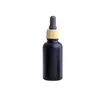 Bottiglia di profumo di olio essenziale liquido in vetro nero opaco con contagocce per pipetta reagente e tappo con venature del legno Confezione da 10/30 ml
