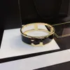 Kvinnliga män designer armband armband lyxigt brev smycken rostfritt stål 18k guld pläterade tofsar armband manschett smycken tillbehör