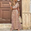 Grundläggande avslappnade klänningar Fashionabla Bohemian Print Dress Women Elegant V Neck Short Sleeve Belt Large Hem Beach Long Dress Sexig High Split Maxi Dresses 230620