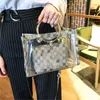 Sommar senior sense transparent väska 2023 ny koreansk version av mode allt-i-ett ring spänne handväska axelväska crossbody väska