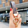 Keychains 2021 Luxury Men'S Waist Buckle Leather Presbyopia Keychain Pendant Car Key Chain Ring Fashion Couple Creative Gift T230625