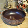 China Artistic Handmade Ceramic Bathroom Sinks Lavobo Round Countertop elegant wash basin brown carving bird pattern Pssjd
