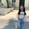 T shirt Çocuk T Gömlek İnce 2023 Yaz Kore Stilleri Mektup Baskılı Kız Moda İpli Baharat Kısa Kollu Rahat Üst 230626