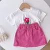 Kläder set sommarflickor kort kjol set blommor vit kort ärm t-shirt halva kjol 2-del mode barns baby korta ärmkläder 230628