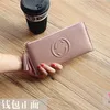 Nueva cartera de moda de cuero de vaca de capa superior con doble cremallera de cuero suave Simple estilo borla genuina larga de mujer coreana modelo 4589