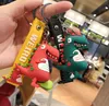 Mignon petit dinosaure poupée Action goutte colle porte-clés mâle et femelle personnalité créative sac pendentif cadeaux