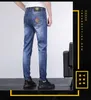 Herenjeans designer lente en zomer dunne kleur hoofd VJ half gezicht katoen elastische blauwe slim legged herenjeans M6E3