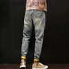 プリントのテーパー付き男子ジーンズが壊れたレトロな韓国のファッションマンカウボーイパンツグラフィックトーンスリムフィットブーツカットホールズボンJ231006