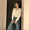 Designer Beige Exquisite Hollow Design Sense Sticked Cardigan Lång ärm Loose Short Blus Female New Autumn Korean version