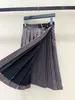 Skirts designer 2023 New Miu Metal Panel Leather Decoration Color Checker Pleated Wool Mid length Half Skirt Women HJE8