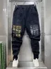 Jeans da uomo Street Jeans Hip Hop Uomo Pantaloni sportivi Harem con cuciture a griglia Novità nel marchio di design Stackes Pantaloni larghi da cowboy Abbigliamento moda J231011