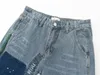 Mäns jeans skarvade tvätt vintage och kvinnors high street fläckiga byxor mikro trasiga avslappnade blossade