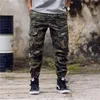 E-BAIHUI moda masculina camuflagem calças de jogging com zíper macacão feixe pé calças irregulares hip hop designer masculino jumm313m