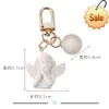 Fashion Charm White Wing Angel Keychain Jelly Color Ball Accessories Car Bag Pendant Earphone Case Ornament Bra gåva för kvinnor
