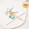 Mignon perle conch key chaîne pendentif fashion charme metal joelry accessoires de femmes bagaux de sac