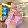 Porte-clés en acrylique avec bouteille de sable mouvant, joli beignet rose, pour sac d'école, voiture, pendentif clé de dessin animé comme jouet ou cadeau pour tout le monde