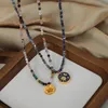 Europe and the United States niche blue spirit gray natural stone hand-beaded design starry sky glazed angel pendant titanium steel gold-plated necklace