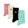 Calcetines agrupados Otoño e Invierno Nuevos calcetines de algodón con letras de Color puro tendencia de moda Ins calcetines de tubo medio alto