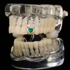 Griglie dentali placcate oro bianco giallo Pietra verde Cuore Grillz Bretelle Denti da vampiro Personalità Hip Hop Donna Uomo Gioielli